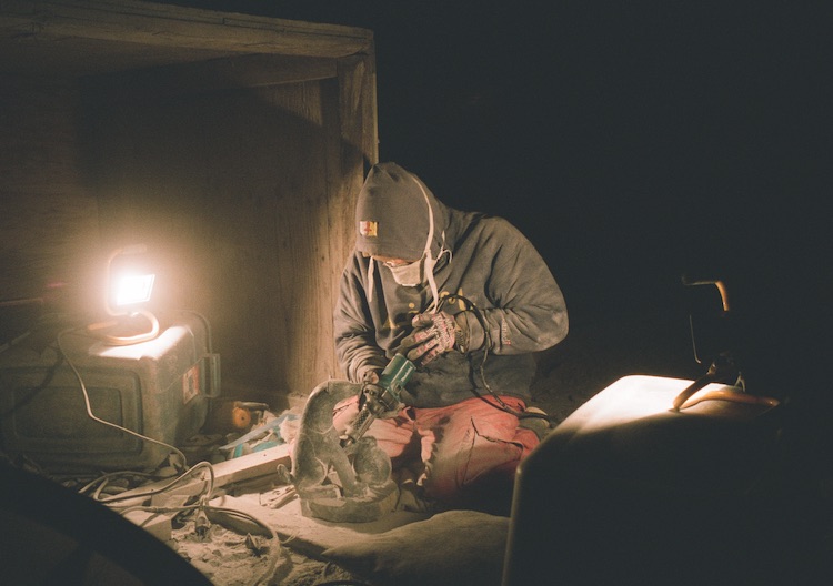Kellypalik Etidloie carves under the stars.