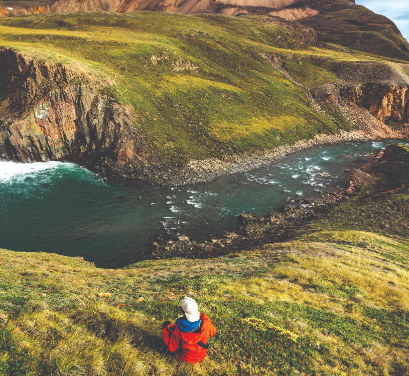 A tourist sits amongst the scenic views of Adams Sound.