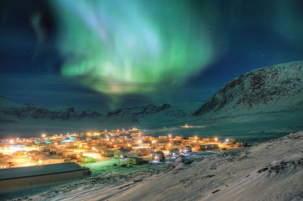 Pangnirtung, lit up by the aurora borealis. CREDIT MICHAEL H. DAVIES