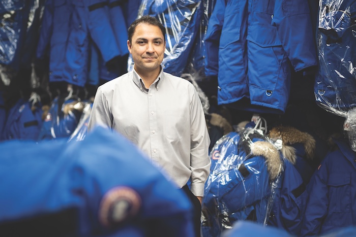Mike Morin, CEO of Aurora Village, stands among the parkas at the company's downtown Yellowknife headquarters. The parkas represent a $600,000 investment by the company.