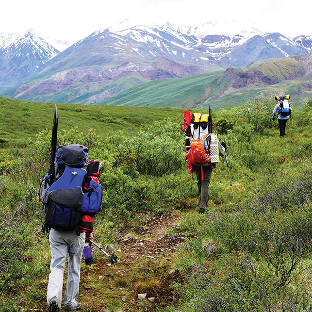 CARRYING YOUR BOAT UP AN OLD KLUANE HORSE TRAIL. Photo courtesy of Paul Burbidge.
