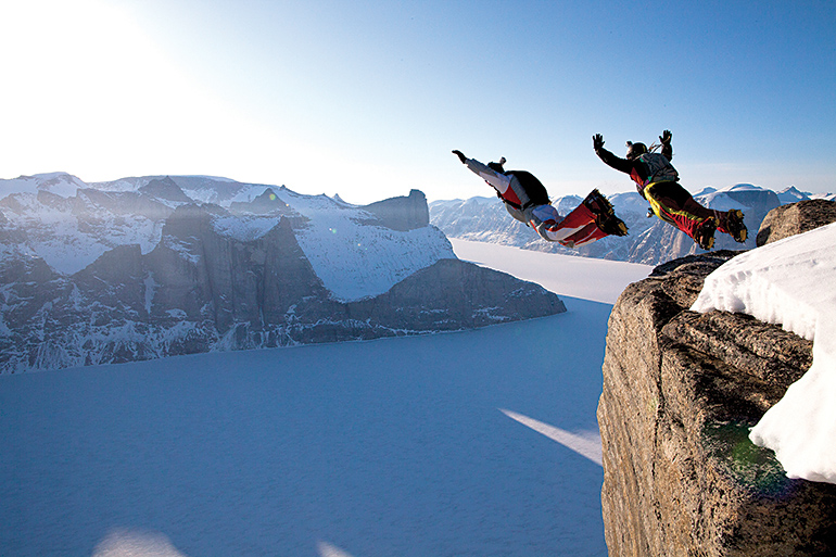 Dressed in track suits, Australians Carly Thomas and Wildman Shovel (yes, that’s really his name) jump the lower exit of the 1,300-metre Ottawa Peak over Sam Ford Fiord. 