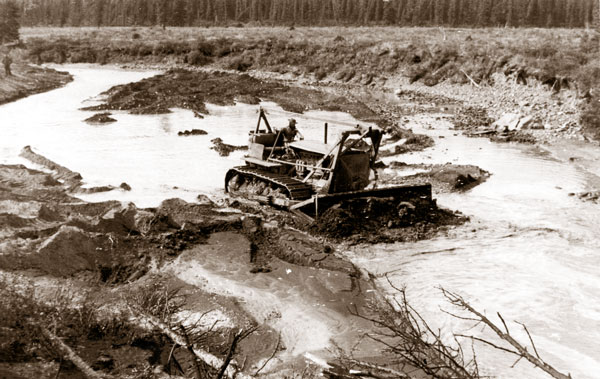 A worker operates a bulldozer in 1942 along the soon-to-be Alaska Highway on the outskirts of Whitehorse. (Yukon Archives/Whitehorse Star Ltd.)