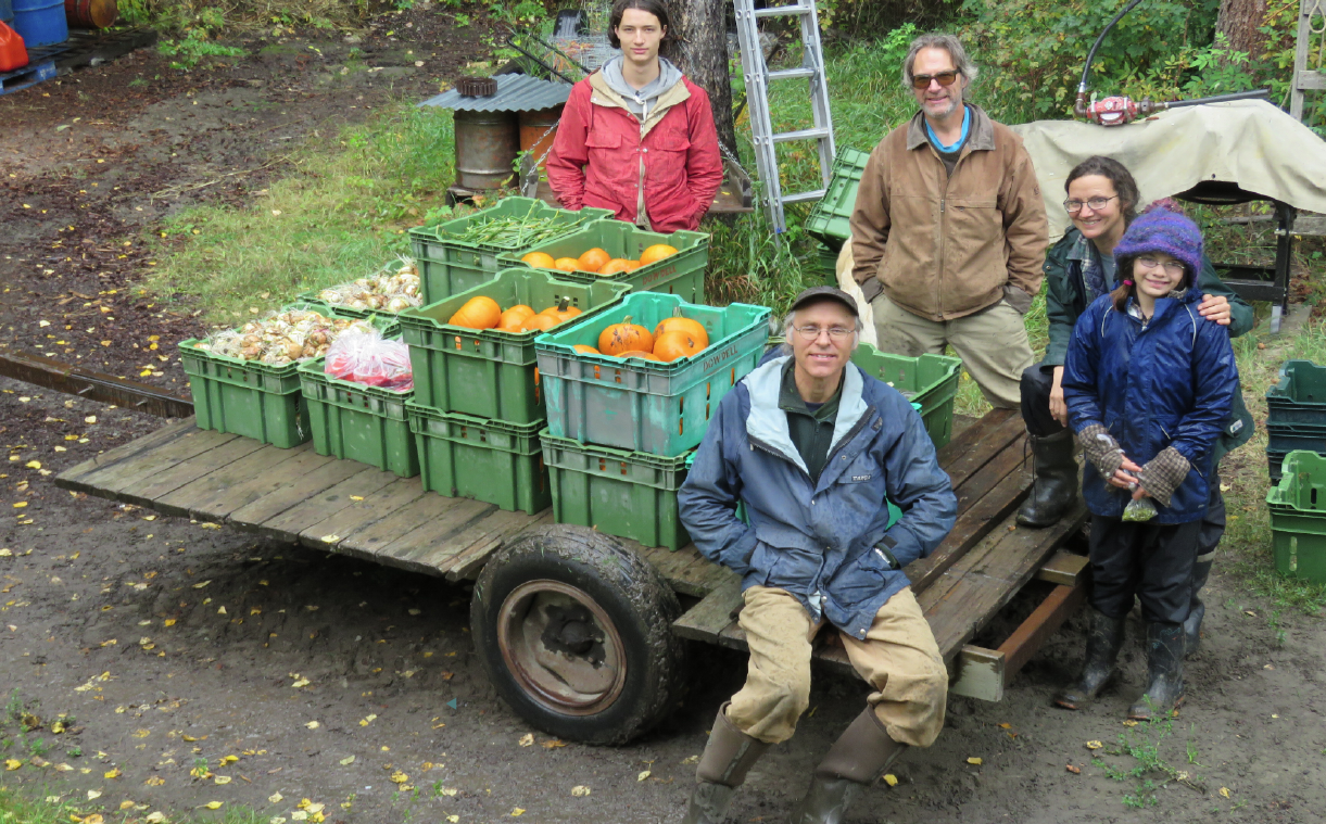 Fall harvest with, clockwise from back left, Crocker’s son Sam, her husband Gerrard, Crocker and her youngest daughter, Tess, and local farmer Grant Dowdell. Here, they pose next to some future pumpkin pie. Courtesy Karen Digby