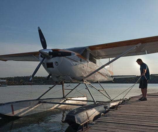 Peter Palme's Cessna 185 is docked steps from the front door of his office. Photo Hannah Eden