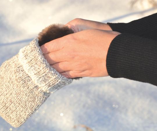 Model puts hand warmer inside mitt