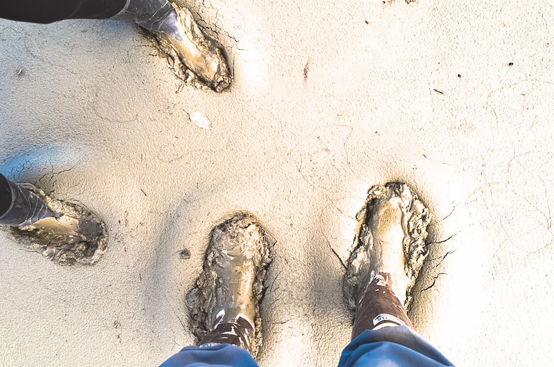 Dan Shugar and his research assistant put their feet into some squishy mud on the Ä’äy Chù delta. Courtesy DAN SHUGAR